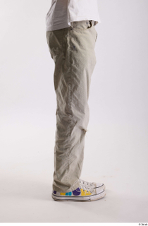 Bryton  1 casual dressed flexing grey jeans leg side…